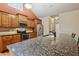 Close-up of a kitchen with granite countertops, stainless steel appliances, and lots of wood cabinet space at 3491 Amerigo Dr, Buford, GA 30519