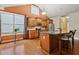 Bright kitchen featuring hardwood floors, granite countertops, stainless steel appliances, and large windows at 3491 Amerigo Dr, Buford, GA 30519