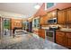 Well-lit kitchen with stainless steel appliances, granite countertops, and open access to the dining area at 3491 Amerigo Dr, Buford, GA 30519