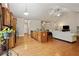 Open kitchen and living area with hardwood floors, a center island, and a cozy fireplace at 3491 Amerigo Dr, Buford, GA 30519