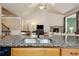 Open kitchen with granite countertops, stainless sink, and view into living space with fireplace at 3491 Amerigo Dr, Buford, GA 30519