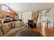 Inviting living room featuring hardwood floors, cozy seating, and seamless access to the kitchen and staircase at 3491 Amerigo Dr, Buford, GA 30519