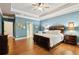 Large main bedroom with wood floors, tray ceilings, and ensuite bathroom access at 3491 Amerigo Dr, Buford, GA 30519