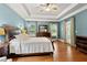 Bright main bedroom with wood floors, tray ceilings, and large windows at 3491 Amerigo Dr, Buford, GA 30519