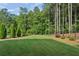 Expansive, well-manicured backyard with lush green grass and mature trees, perfect for outdoor activities at 400 Southland Cir, Canton, GA 30115