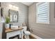 Stylish half bathroom with shiplap walls, modern fixtures, and natural light at 400 Southland Cir, Canton, GA 30115