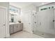 Modern bathroom features a glass shower, gray cabinets, and large vanity mirror at 400 Southland Cir, Canton, GA 30115