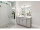 Modern bathroom features a glass shower, gray cabinets, and large vanity mirror at 400 Southland Cir, Canton, GA 30115