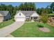 Beautiful home with green lawn, attached garage, and attractive landscaping at 400 Southland Cir, Canton, GA 30115