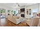 Bright living room with fireplace, built-ins, and large windows overlooking the backyard at 400 Southland Cir, Canton, GA 30115