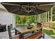 Outdoor dining area features a large table under an umbrella with a beautiful, wooded backyard at 400 Southland Cir, Canton, GA 30115
