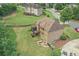 Aerial view of brick home featuring fenced yard, patio, and green lawn in a residential neighborhood at 602 Davenport Pl, Canton, GA 30115