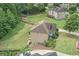 Aerial view of a brick home showing the backyard, patio and lush green lawn at 602 Davenport Pl, Canton, GA 30115