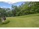 Expansive backyard featuring lush green lawn with ample space for outdoor activities surrounded by mature trees at 602 Davenport Pl, Canton, GA 30115
