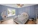 Charming bedroom features a hanging chair, natural light, and hardwood floors at 602 Davenport Pl, Canton, GA 30115