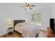 Bright bedroom featuring hardwood floors, ceiling fan, and large window with lots of light at 602 Davenport Pl, Canton, GA 30115