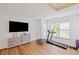 Bright exercise room with treadmill, light walls, and wood floors, perfect for a home gym at 602 Davenport Pl, Canton, GA 30115