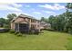 View of the home's back exterior, showcasing a screened-in porch, large deck, and beautifully landscaped yard at 602 Davenport Pl, Canton, GA 30115