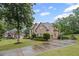 Beautiful brick home with well-manicured lawn and long driveway in a lush, green neighborhood at 602 Davenport Pl, Canton, GA 30115