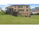 Rear exterior of the home showcasing a spacious backyard, a screened porch, a deck, and outdoor seating area at 602 Davenport Pl, Canton, GA 30115