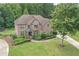 Beautiful brick home with lush landscaping, sprawling lawn, and a charming covered entryway at 602 Davenport Pl, Canton, GA 30115