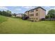 Exterior view of the home's backyard featuring a lush green lawn, a deck, and a screened porch, creating an ideal outdoor space at 602 Davenport Pl, Canton, GA 30115