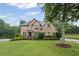 Charming two-story brick home with a beautifully landscaped front yard and mature tree at 602 Davenport Pl, Canton, GA 30115
