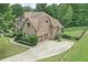 Brick home with a two-car garage, spacious driveway, and a well-maintained lawn at 602 Davenport Pl, Canton, GA 30115