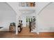Elegant two-story foyer featuring hardwood floors, decorative lighting, and a staircase with iron railings at 602 Davenport Pl, Canton, GA 30115