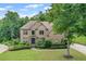 Beautiful brick home featuring lush landscaping, a well-manicured lawn, and a welcoming entrance at 602 Davenport Pl, Canton, GA 30115