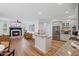 Spacious open-concept kitchen with stainless steel appliances, granite counters, and a cozy fireplace at 602 Davenport Pl, Canton, GA 30115