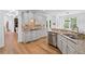 Well-lit kitchen with stainless steel appliances, granite countertops, and ample cabinet space at 602 Davenport Pl, Canton, GA 30115