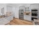 Bright kitchen featuring stainless steel appliances, granite countertops, and stylish white cabinetry at 602 Davenport Pl, Canton, GA 30115