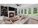 Inviting living room with a fireplace, built-in shelving, and lots of natural light at 602 Davenport Pl, Canton, GA 30115