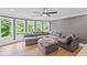 Well-lit living room offers ample seating, hardwood floors, recessed lights, and wooded backyard views at 602 Davenport Pl, Canton, GA 30115