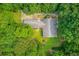 Aerial shot of the home showcasing its roof, lush surrounding greenery, and well-maintained lawn at 1980 Mcconnell Rd, Grayson, GA 30017