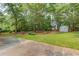 Spacious backyard featuring lush green grass, mature trees, and a charming storage shed at 1980 Mcconnell Rd, Grayson, GA 30017