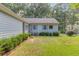 The home's back exterior features tidy landscaping, complemented by light blue shutters and siding at 1980 Mcconnell Rd, Grayson, GA 30017