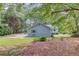 View of the home and surrounding landscaping from the backyard, featuring lush trees and shrubs at 1980 Mcconnell Rd, Grayson, GA 30017