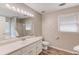 Bathroom with double sink vanity, large mirror, and natural light at 1980 Mcconnell Rd, Grayson, GA 30017
