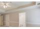 Bedroom featuring neutral walls and trim, ceiling fan, and a hallway to the bathroom at 1980 Mcconnell Rd, Grayson, GA 30017