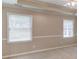 Bedroom with neutral walls and carpet, featuring natural light and a ceiling fan at 1980 Mcconnell Rd, Grayson, GA 30017