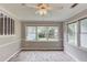 Open dining room with ample windows, ceiling fan, and stylish flooring at 1980 Mcconnell Rd, Grayson, GA 30017
