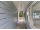 Covered outdoor walkway featuring blue siding, trim, windows, and concrete floor at 1980 Mcconnell Rd, Grayson, GA 30017