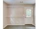 Room with metal storage shelving and a glass paneled door to the exterior at 1980 Mcconnell Rd, Grayson, GA 30017