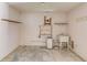 Unfinished basement with storage shelves, sink, and hot water heater at 1980 Mcconnell Rd, Grayson, GA 30017