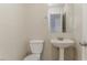 Updated half-bathroom featuring a pedestal sink and decorative mirror at 2341 Alden, Jonesboro, GA 30236