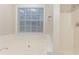 Bathroom with bathtub, shower, and window for natural light at 2341 Alden, Jonesboro, GA 30236