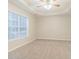 Bright bedroom featuring ceiling fan, neutral walls, cozy carpet, and a window at 2341 Alden, Jonesboro, GA 30236