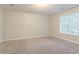 Bright bedroom featuring neutral walls, cozy carpet, and a window providing natural light at 2341 Alden, Jonesboro, GA 30236